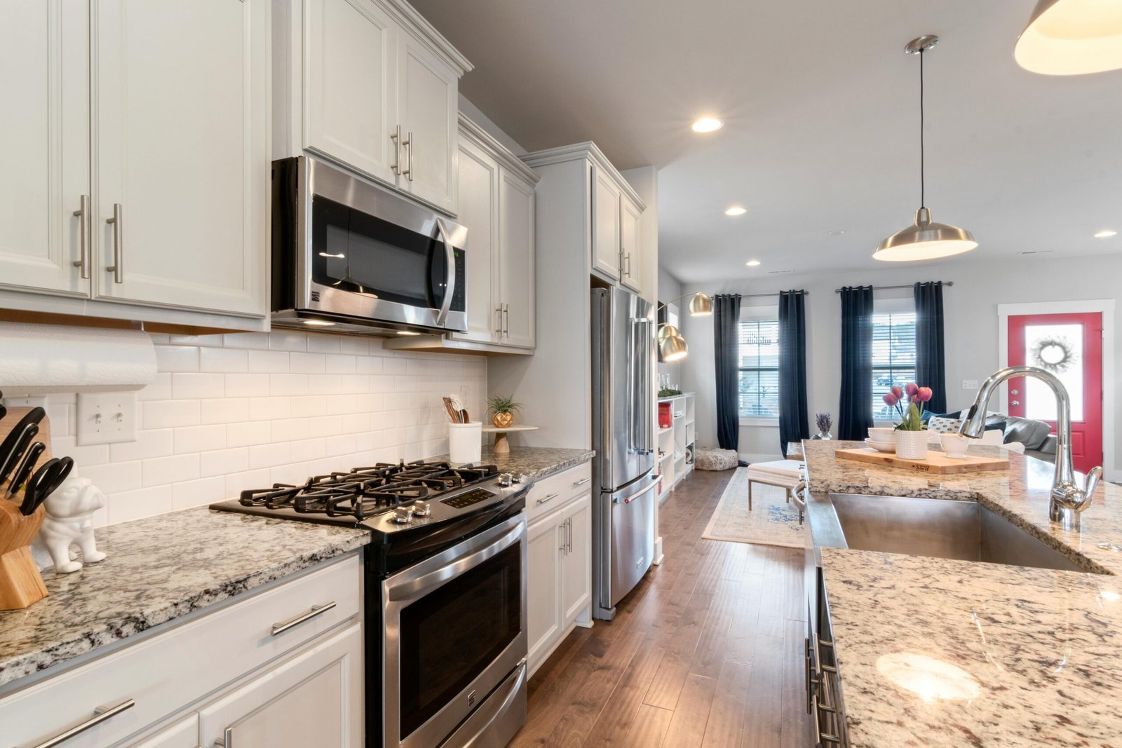 Bright modern kitchen featuring granite countertops and stainless steel appliances.